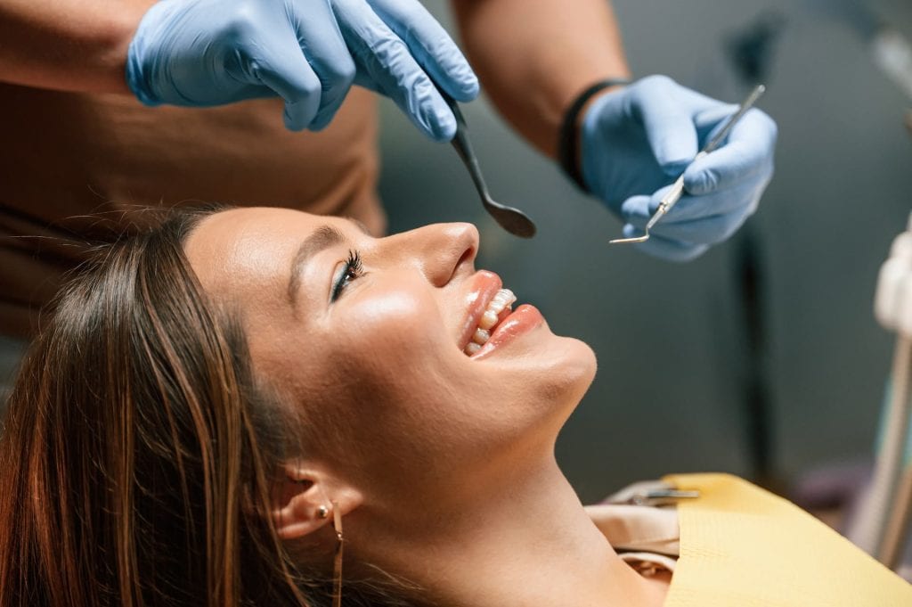 smiling patient with hygienist