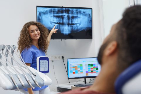 Dentist reviewing an X-ray with a patient for root canal treatment in Waterford