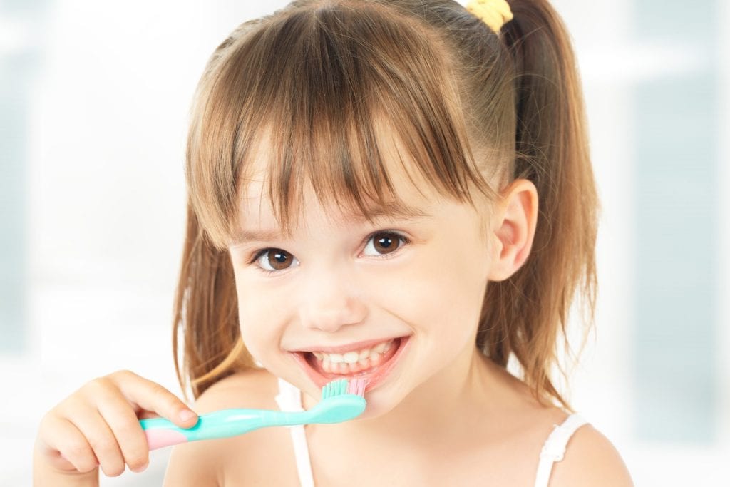 child brushing teeth